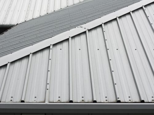 Architectural detail of metal roofing on commercial construction of modern building complex